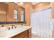 Bathroom with shower, wood vanity, and patterned curtain at 9025 N Flying Butte --, Fountain Hills, AZ 85268