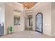 Bright and spacious entryway with a large chandelier and tile floors at 9025 N Flying Butte --, Fountain Hills, AZ 85268