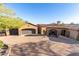 Front view of a luxurious, Spanish-style home with a large driveway and mature landscaping at 9025 N Flying Butte --, Fountain Hills, AZ 85268