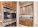 Built-in oven and microwave in this kitchen with custom wood cabinetry at 9025 N Flying Butte --, Fountain Hills, AZ 85268