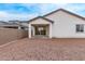 Exterior back view of a house with a covered patio area and spacious dirt backyard at 18795 E Elizar Dr, Gold Canyon, AZ 85118