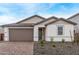 Charming single-story home featuring a well-maintained front yard and a two-car garage at 18795 E Elizar Dr, Gold Canyon, AZ 85118