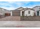 Lovely single-story home featuring a brick driveway, two-car garage, and low-maintenance landscaping at 18795 E Elizar Dr, Gold Canyon, AZ 85118