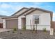 Charming single-story home with desert landscaping, neutral stucco, and a two-car garage at 18795 E Elizar Dr, Gold Canyon, AZ 85118