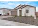 Charming single-story home with desert landscaping, neutral stucco, and a two-car garage at 18795 E Elizar Dr, Gold Canyon, AZ 85118