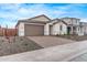 Charming single-story home featuring a brick driveway, neutral tones, and a well-manicured gravel front yard at 18795 E Elizar Dr, Gold Canyon, AZ 85118
