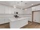 Spacious kitchen with white cabinets, stainless steel appliances, and a large center island at 18795 E Elizar Dr, Gold Canyon, AZ 85118