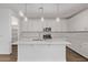 Modern kitchen boasts white cabinets, stainless steel appliances, and a large center island at 18795 E Elizar Dr, Gold Canyon, AZ 85118