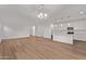 Open-concept living space with wood floors flowing into a well-equipped kitchen at 18795 E Elizar Dr, Gold Canyon, AZ 85118