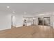 Open-concept living area with wood floors and access to the kitchen and outdoor patio at 18795 E Elizar Dr, Gold Canyon, AZ 85118