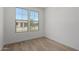 An empty bedroom features luxury vinyl plank flooring and a pair of windows at 18507 E Camila Dr, Gold Canyon, AZ 85118