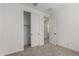 This bedroom features neutral carpet, a closet, and an open door to an adjacent room at 18507 E Camila Dr, Gold Canyon, AZ 85118