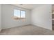 Bright bedroom with a large window, neutral carpet, and a light-filled atmosphere at 18507 E Camila Dr, Gold Canyon, AZ 85118
