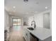 Modern kitchen overlooking the living area, featuring an island with seating and stainless steel appliances at 18507 E Camila Dr, Gold Canyon, AZ 85118