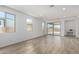 Bright living room with neutral walls, wood-look flooring, and access to a backyard patio at 18507 E Camila Dr, Gold Canyon, AZ 85118
