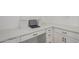 This office area features white cabinets, drawers, shelves, and a built-in desk at 18507 E Camila Dr, Gold Canyon, AZ 85118