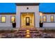 Inviting home entrance featuring a brick pathway, decorative planters and glass paneled door at 17448 W Carlisle Dr, Surprise, AZ 85388