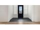 Bright foyer featuring black tile flooring, crisp white walls, and a front door with side lites at 17448 W Carlisle Dr, Surprise, AZ 85388