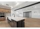 Modern kitchen featuring a large island with sink and stainless steel appliances at 17448 W Carlisle Dr, Surprise, AZ 85388