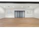 A spacious, light-filled room with hardwood floors and sliding glass doors to the backyard at 17448 W Carlisle Dr, Surprise, AZ 85388