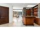 Stylish bar area with custom cabinets, stone accents, and a view of the dining area at 11070 E Rolling Rock Dr, Scottsdale, AZ 85262
