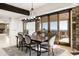 Elegant dining room with stone accent wall, hardwood table, and sliding doors to outdoor living at 11070 E Rolling Rock Dr, Scottsdale, AZ 85262