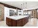 Open kitchen with large island, custom cabinets, and stainless steel appliances at 11070 E Rolling Rock Dr, Scottsdale, AZ 85262