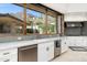 Kitchen with granite counters, stainless appliances, and a view to a mountain and the outdoors at 11070 E Rolling Rock Dr, Scottsdale, AZ 85262