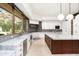 Bright modern kitchen featuring marble countertops, stainless steel appliances, and backyard views at 11070 E Rolling Rock Dr, Scottsdale, AZ 85262