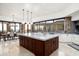 Modern kitchen with a large island, stainless steel appliances, and an adjacent dining area at 11070 E Rolling Rock Dr, Scottsdale, AZ 85262