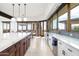 Kitchen featuring stainless steel appliances, marble counters, an island, and dining area at 11070 E Rolling Rock Dr, Scottsdale, AZ 85262