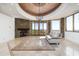 Spacious living room with a stone fireplace, large windows, and stylish furnishings at 11070 E Rolling Rock Dr, Scottsdale, AZ 85262
