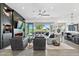 Bright living room with a modern fireplace, sleek built-ins, and a sliding glass door to the patio at 17316 W Wildwood St, Surprise, AZ 85388