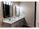 Bathroom featuring double sinks, black framed mirrors, and modern lighting at 4030 N Palm Cir, Eloy, AZ 85131