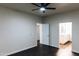 Spacious bedroom with hardwood floors, ceiling fan, and bathroom access at 4030 N Palm Cir, Eloy, AZ 85131