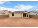 A large dirt backyard with block wall fencing and a covered patio to the house at 18740 E Elizar Dr, Gold Canyon, AZ 85118