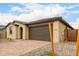 Single-Gathering home boasts a two-car garage, tiled roof, and desert landscaping at 18740 E Elizar Dr, Gold Canyon, AZ 85118