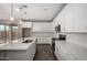 Modern kitchen featuring white cabinetry, stainless steel appliances, a spacious island, and stylish pendant lighting at 18740 E Elizar Dr, Gold Canyon, AZ 85118