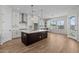 Modern kitchen featuring white cabinets, a dark island, stainless steel appliances, and stylish pendant lighting at 4315 S 123Rd Ave, Avondale, AZ 85323