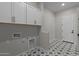 Functional laundry room with ample cabinet storage, stylish patterned tile flooring, and convenient utility connections at 4315 S 123Rd Ave, Avondale, AZ 85323