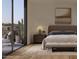 Cozy bedroom with light wood floors and access to a private balcony with city views at 4849 N Camelback Ridge Rd # A409, Scottsdale, AZ 85251