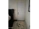 A bedroom with a white door and stained floor at 5007 W Weldon Ave, Phoenix, AZ 85031