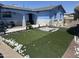 Charming blue single-story home featuring newly installed artificial grass and rock details at 5007 W Weldon Ave, Phoenix, AZ 85031