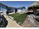 Charming blue single-story home featuring newly installed artificial grass and rock details at 5007 W Weldon Ave, Phoenix, AZ 85031