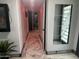 Hallway with patterned floor and large mirror is illuminated by modern overhead lighting at 5007 W Weldon Ave, Phoenix, AZ 85031