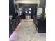 Spacious kitchen with black cabinets, stainless steel refrigerator, and stone-look flooring at 5007 W Weldon Ave, Phoenix, AZ 85031
