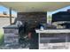 This outdoor kitchen is under a covered patio and includes a grill and sink at 5007 W Weldon Ave, Phoenix, AZ 85031