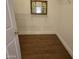 Walk-in closet featuring wooden floors, wire shelving and a mirror at 19595 N Sunburst Way, Surprise, AZ 85374