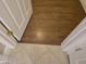 Close-up of the transition between hardwood and tile flooring in an entryway at 19595 N Sunburst Way, Surprise, AZ 85374