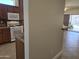 Kitchen adjacent to living room showcasing warm cabinetry, tile backsplash, and white appliances at 19595 N Sunburst Way, Surprise, AZ 85374